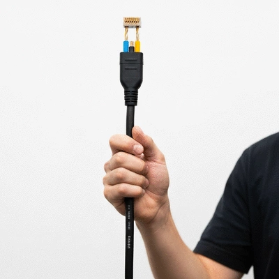 Hand holding a modern electrical cable, symbolizing innovation and energy transition