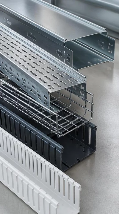 Close-up of different types of cable trays: metal, plastic, and perforated, organized neatly